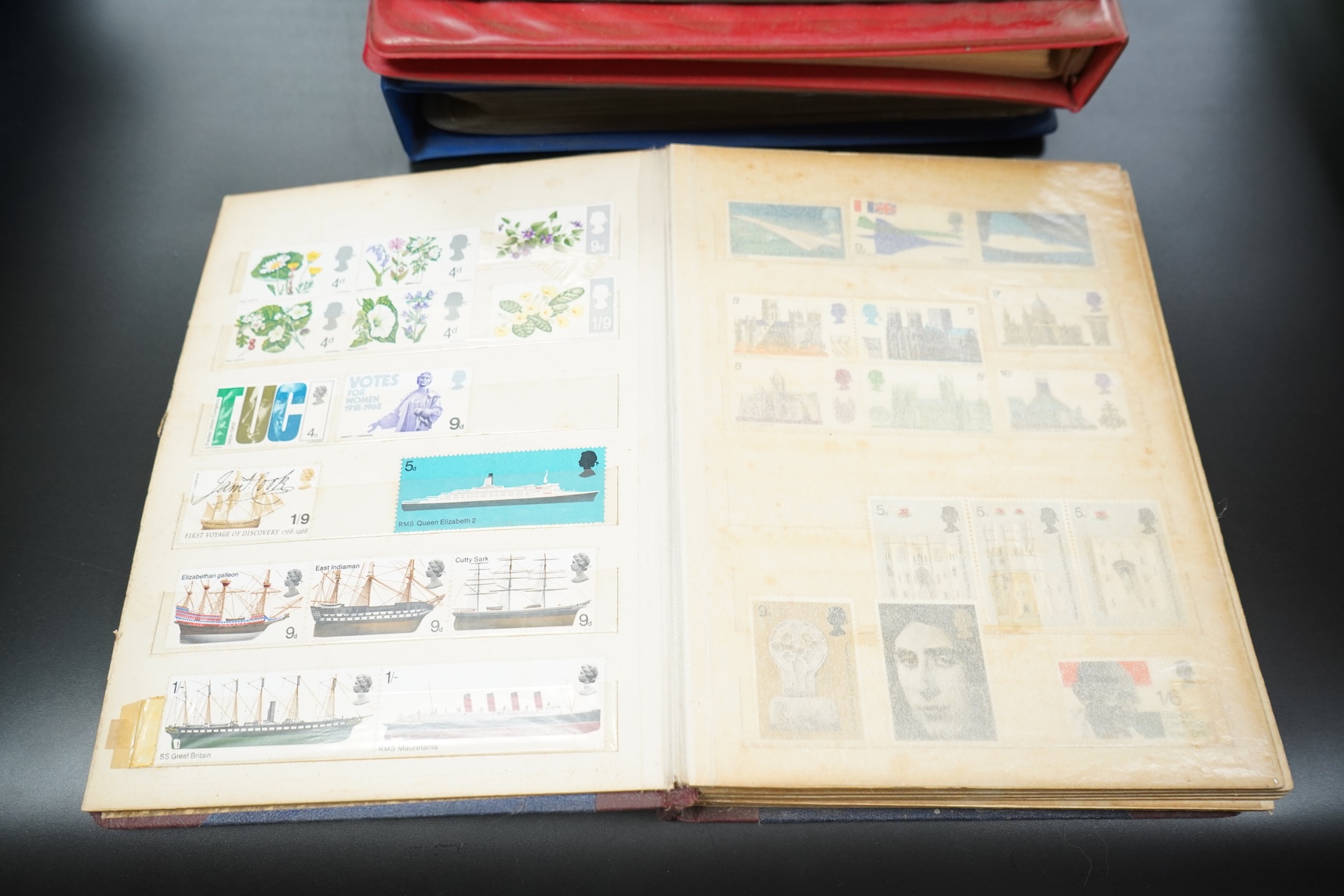 Four stamp albums including a first day cover album